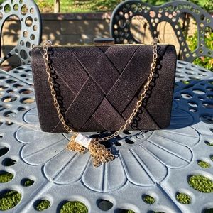 Black purse with long gold chain